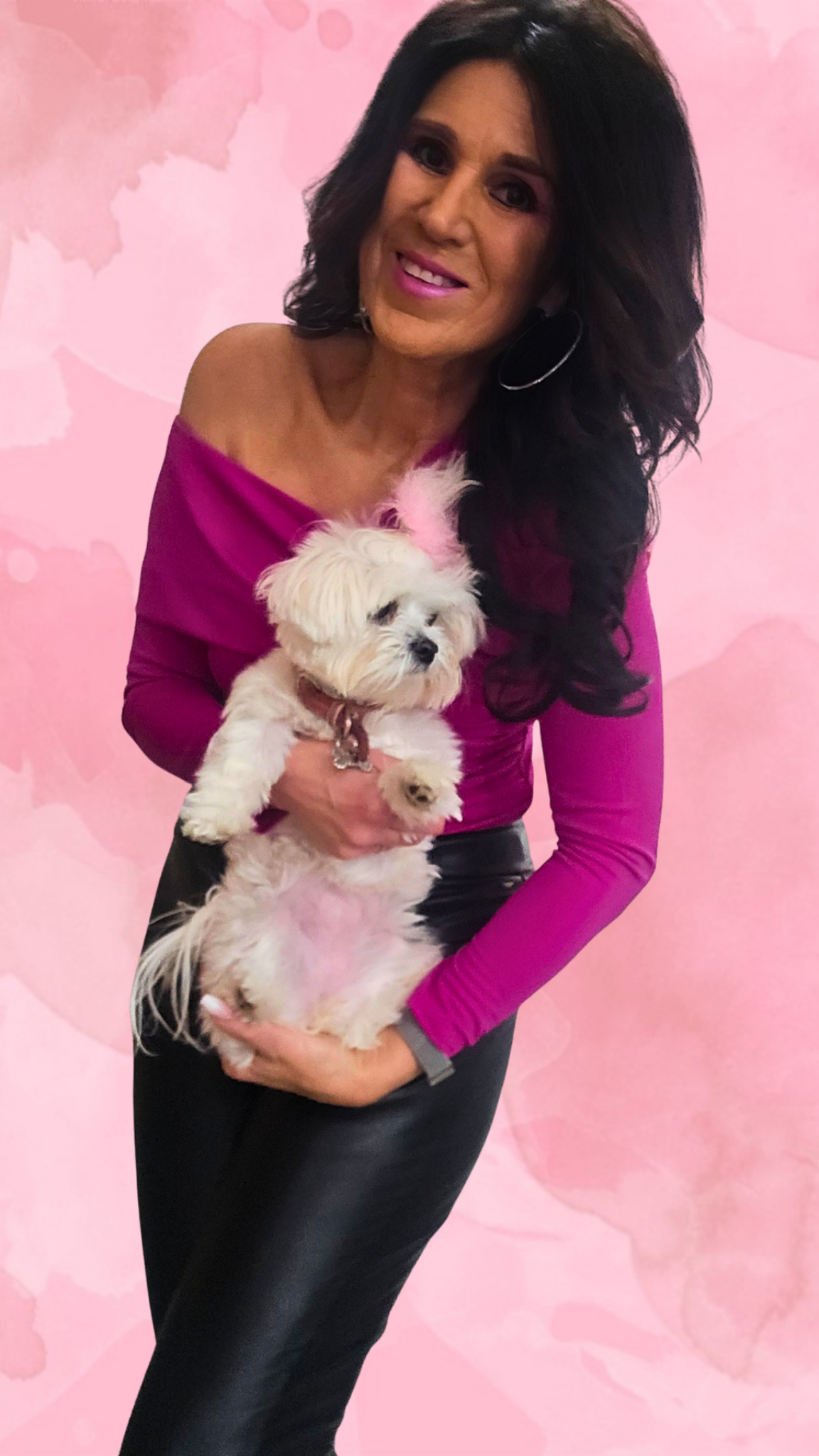 Dawn Marie holding a small white dog